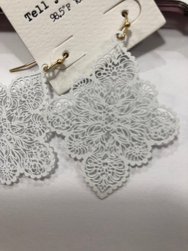 White ornate earrings