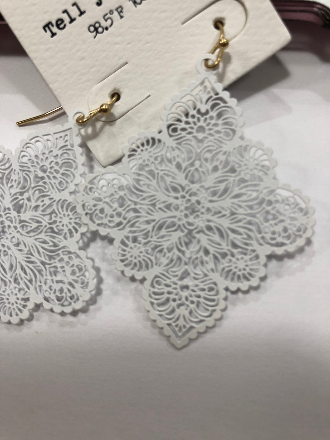 White ornate earrings