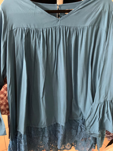 Blue top with bell sleeve and less bottom button in the back