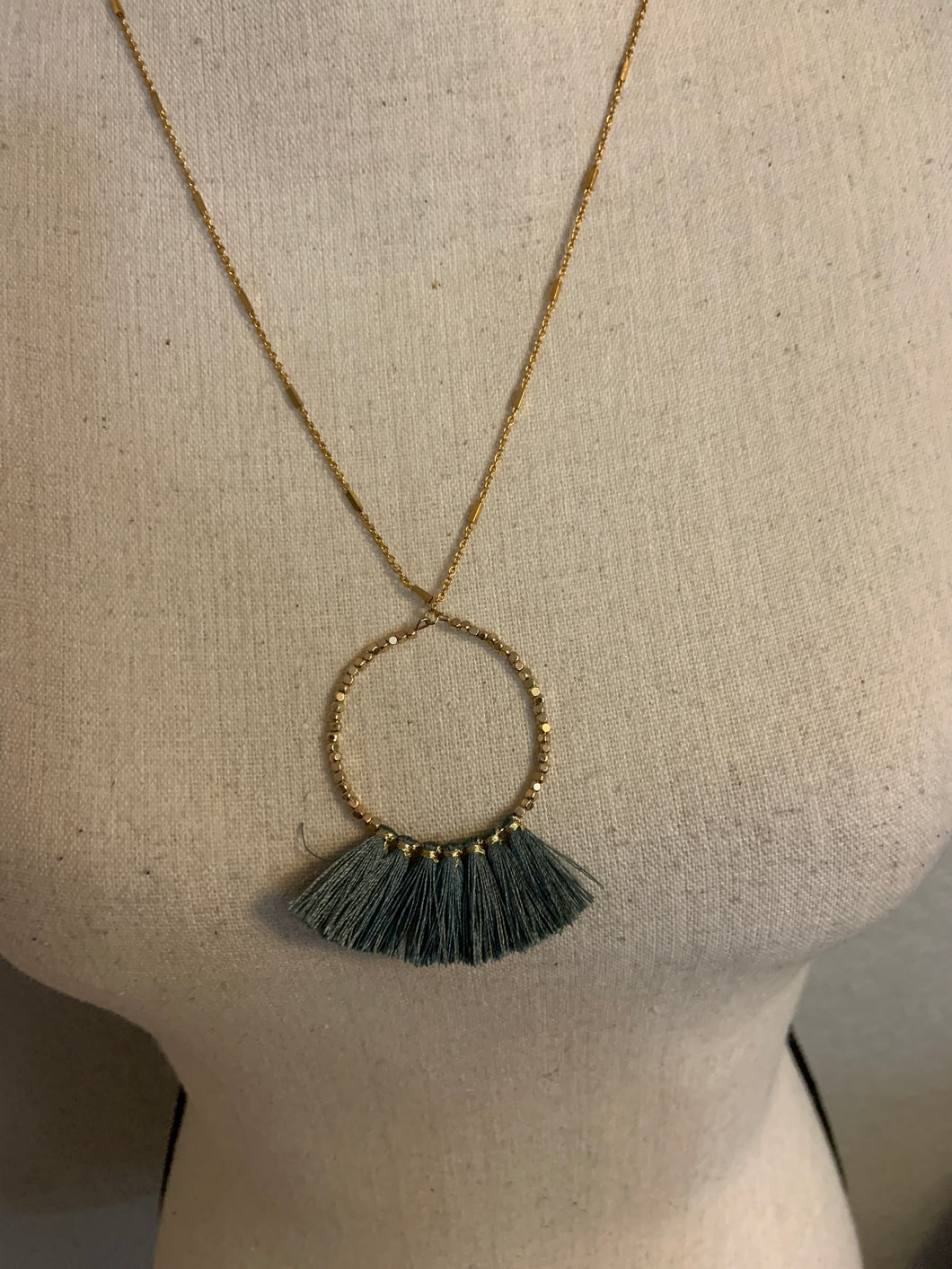 Gray tassel with gold necklace