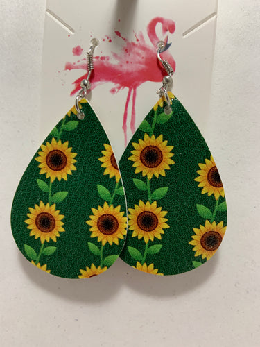 Sunflower earrings with a green background