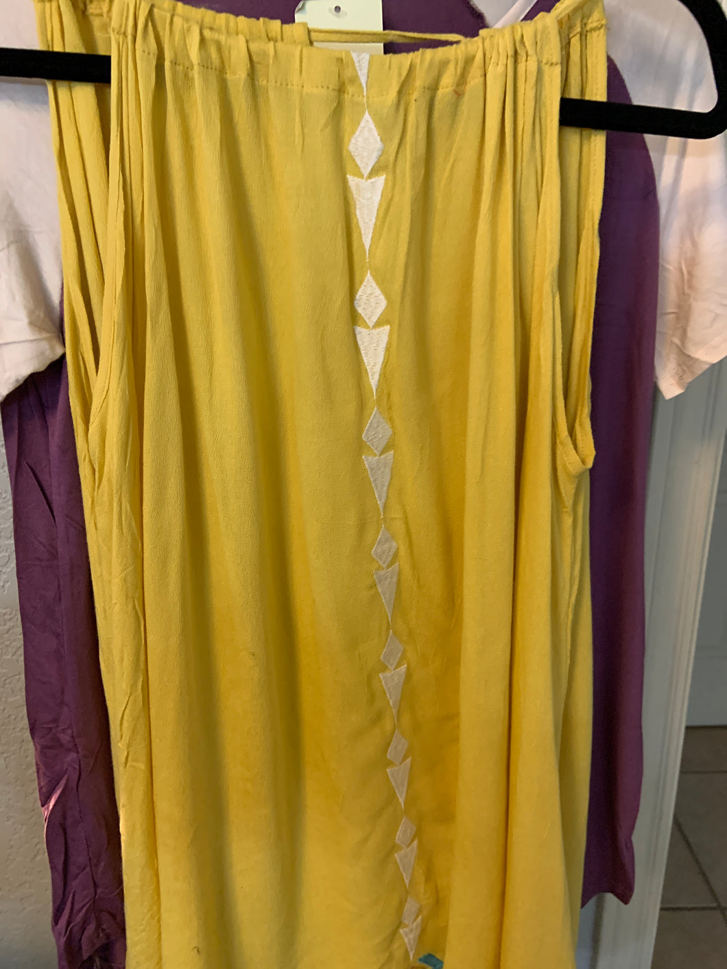 Yellow tank top with embroidery and tassel